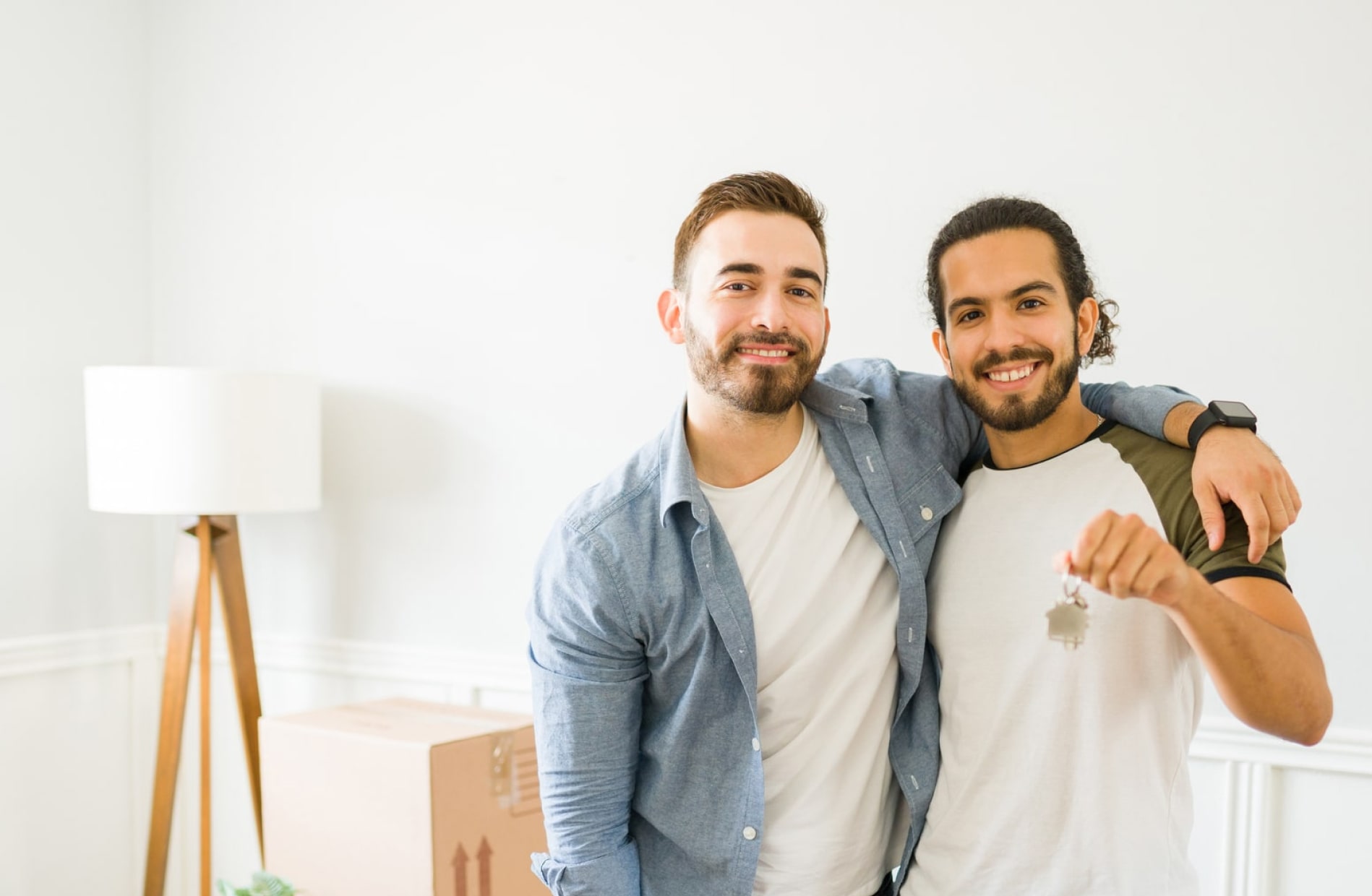 A couple standing in a house with keys
